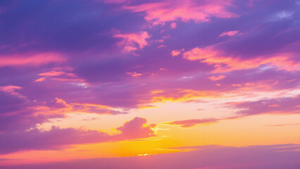 Fototapeta premium A colorful sky with hues of pink purple and orange during sunset with scattered clouds in the horizon