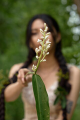 Obraz premium Female model posing in lace gown outdoors.