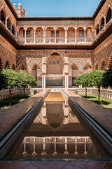 Naklejka premium The Courtyard of the Maidens or Patio de las Doncellas in the Real Alcazar de Sevilla or the Royal Alcazar of Seville in Spain. 