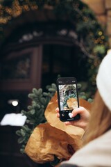 Capturing a Moment in Front of a Festive Door With Holiday Decorations