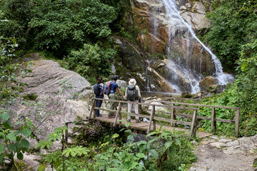 A group of tourists pause in awe along the Inca Trail. United by discovery, they share a moment of amazement on this legendary journey toward Machu Picchu.