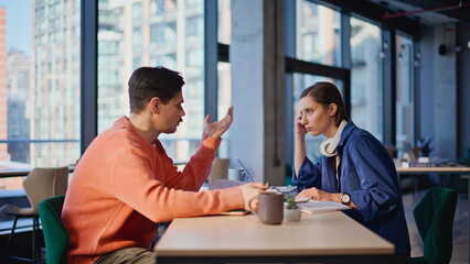 Worried partners solving problems at office closeup. Two stressed colleagues