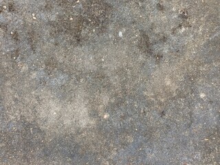 Close-up of a textured, uneven surface with varying shades of gray and black.