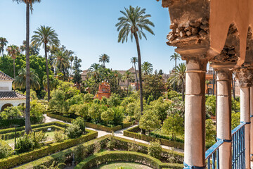 Obraz premium A high-up view overlooking the gardens at the Real Alcazar de Sevilla or the Royal Alcazar of Seville in Spain. 