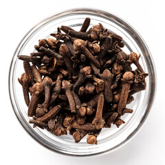 Top view of a glass bowl filled with whole dried cloves. Aromatic spice used in cooking, baking, mulled wine, and exotic recipes.