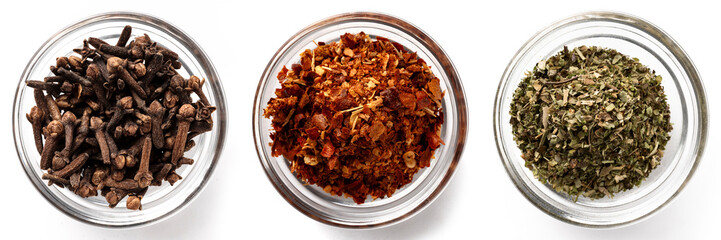High-resolution image of three types of dried spices in transparent glass bowls on a white background, top view.