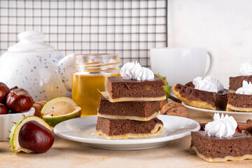 Homemade autumn taste chestnut pie bars. Freshly baked chestnut bars with whipped cream on it, with...