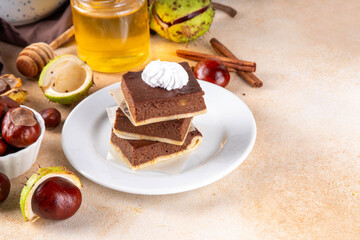 Homemade autumn taste chestnut pie bars. Freshly baked chestnut bars with whipped cream on it, with...
