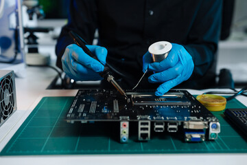 Hands repairing electronic devices. Electronic technician.