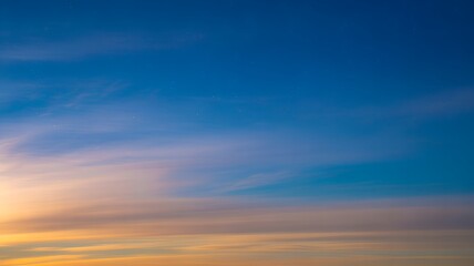 Obraz premium Wispy Clouds at Sunset with Faint Stars twilight dusk.