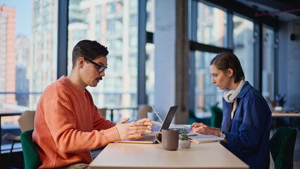 Stressed business people failing project looking laptops at workplace closeup.