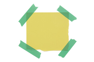 yellow note taped to a surface with green tape isolated on white background