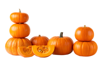 A group of bright orange pumpkins stacked and arranged with slices on a black background studio shot