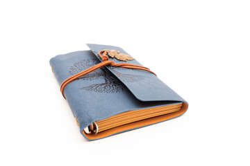 A vintage leather-bound journal with an embossed Tree of Life design and a leather cord closure, presented on a white background for a creative and nostalgic concept