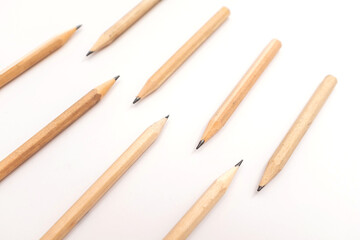 Wooden graphite pencils arranged on white background, minimal stationery concept for writing, sketching, office, school or creative art use, symbol of study, drawing, education, simplicity, and design