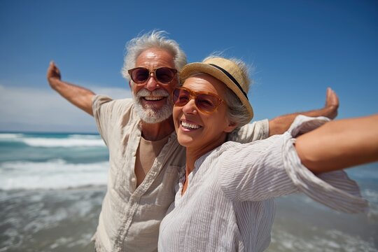 Happy senior couple taking a joyful selfie on a sunny beach