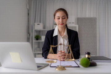 Fototapeta premium Asian Women Attorney Analyzing Legal Documents in Office Scale of Justice Laptop Legal Gavel Lawyer Courtroom Legislation Litigation Advocate Professional Judgement