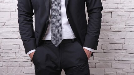 Businessman in formal suit pulling out empty pockets to show no money, concept of financial crisis, debt, bankruptcy, economic hardship, business loss, and personal struggle in 4k video - Powered by Adobe