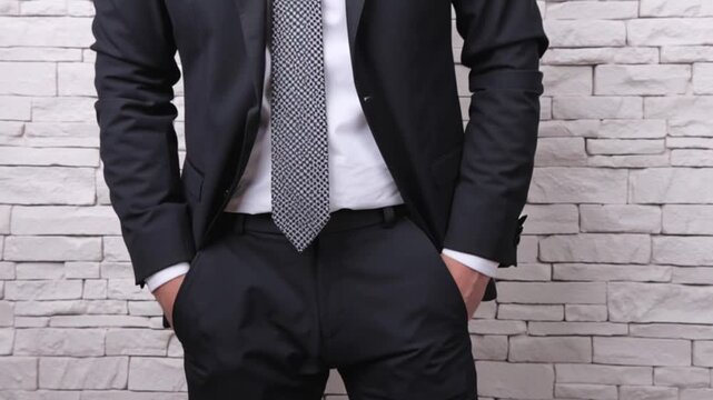 Businessman in formal suit pulling out empty pockets to show no money, concept of financial crisis, debt, bankruptcy, economic hardship, business loss, and personal struggle in 4k video