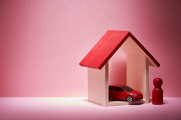 wood figurind and wooden model house and toy red car