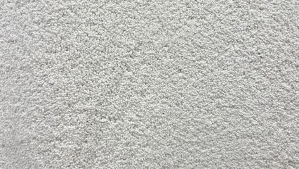 White shag carpet texture close up from above – soft fluffy rug textile background for interior design and decor