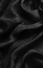Draped black fabric with subtle texture and folds, creating a dark, moody aesthetic.  The image showcases the material's soft sheen and flowing movement
