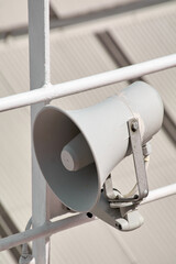 A public address speaker, part of the onboard communication infrastructure, is installed on a ships deck for safety and service purposes.