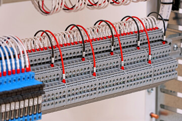 Electrical screw terminals for connecting wires in an electrical switchboard. Soft focus. Close-up.