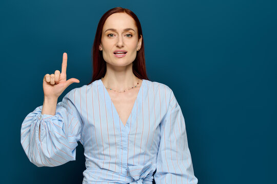 Language teacher with red hair shares sign language lessons with enthusiasm - Powered by Adobe