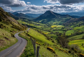 Fototapeta premium Winding road through a valley of rolling hills (1)