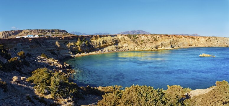 Rocky Paralia Agios Theodoros Bay with clear blue water under a clear sky, Arkasa, Karpathos, Greece