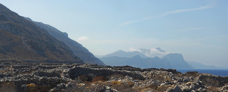Expansive view of the ancient Doric city of Vrougounda to the mountains and sea with a clear sky, Doric city of Vrougounda, Avlona, Karpathos, Greece