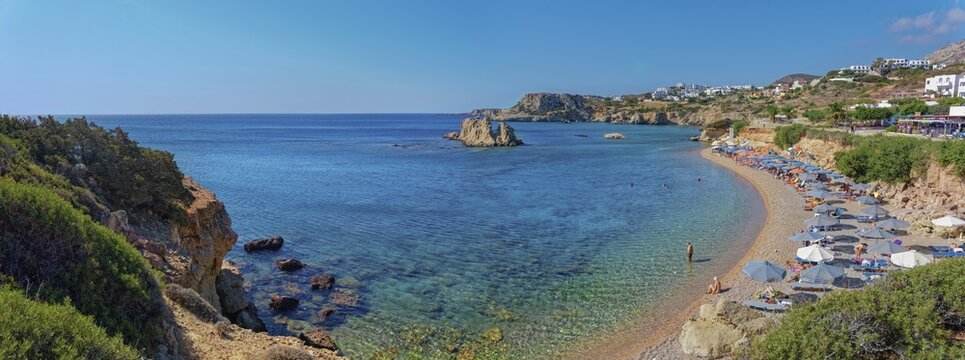 Paralia sandy beach with parasols and clear water, Ammopi, Karpathos town, Karpathos, Greece