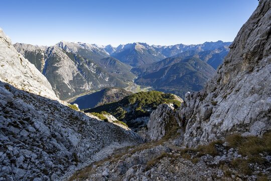 Mountain landscape in autumn, ascent to the Gro&szlig;e Arnspitze, view into the valley to Scharnitz with Pleisenspitze, near Scharnitz, Bavaria, Germany