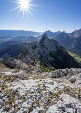 View at the summit of the Gro&szlig;e Arnspitze, mountain panorama with Karwendel Mountains and Arnplattenspitze, sun star, autumnal mountain landscape, near Scharnitz, Bavaria, Germany