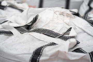 A big bag package, using to contain chemical or sand material that prepare for the transportation. Industrial equipment object.