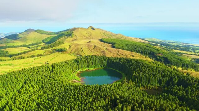 Hills, Forest and Lake Lagoa do Canario on Sunny Evening. Azores, Sao Miguel Island, Portugal. Aerial View. Drone Moves Forward