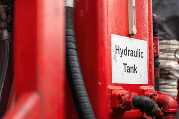 Hydraulic oil tank with gauge level of the pumping machine engine. Industrial equipment object, close-up.