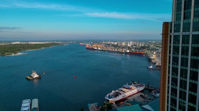 Aerial view of Dar es Salam harbor bay with modern buildings in cloudy sky, Tanzania