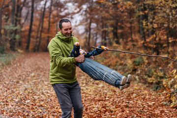 Fototapeta premium Father and son bonding. Autumn fall images. 