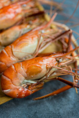 Close up of fresh boiled shrimp in wood plate