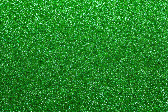 Vibrant emerald green glitter sparkle texture background with subtle shimmer