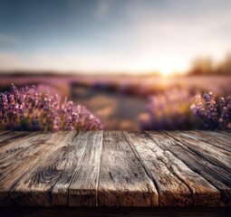 Rustic wooden tabletop extends into a field of vibrant purple lavender blossoms at sunset.