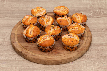 Group of muffins served on wooden tray