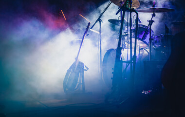 musical instruments on stage with dramatic concert lighting and smoke