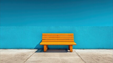 Bright orange wooden park bench against a vivid blue wall with textured surface and contrasting