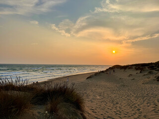 sunset at a coast with dunes near Marbella, view to the Mediterranean Sea, Costa del Sol in the summer, Andalusia, Spain	