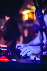musician playing keyboard on stage during live concert