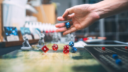 Man hand dice roll d20 for critical hit attack role playing tabletop game and board game hobby