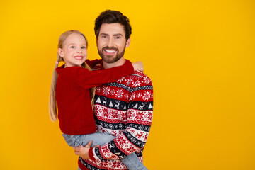 Single father and daughter bonding in festive sweaters with a joyful holiday spirit against a...